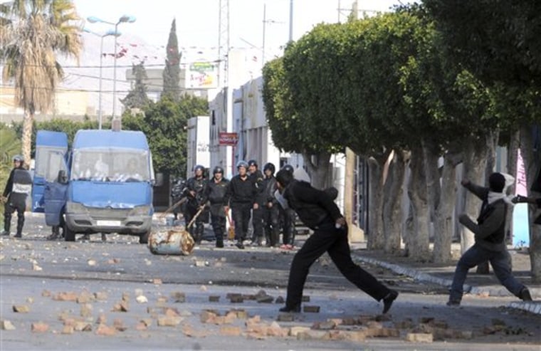 Demonstrators throw stones at police officers in Sidi Bouzid, Tunisia, Monday Jan. 10, 2011. Tunisia's Interior Ministry said Monday that 14 people were killed in weekend rioting in three towns in the deadliest episodes in more than three weeks of unusual unrest in this popular tourist destination. Union officials around Tunisia have provided their own death counts, higher than the official number. 
